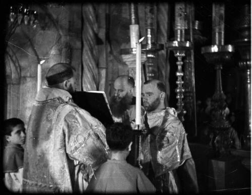 [Priests during service, Church of the Holy Sepulchre, Jerusalem] [picture] / [Frank Hurley]