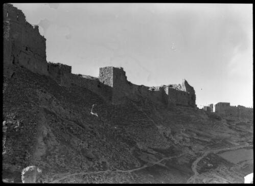 [Towers, wall and sloping stone embankment of unidentified Crusader castle, Middle East] [picture] / [Frank Hurley]