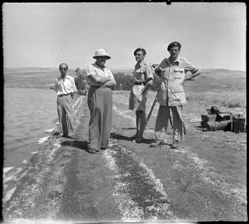 Wady ain Farre [standing in field beside photographic equipment] [picture] / [Frank Hurley]