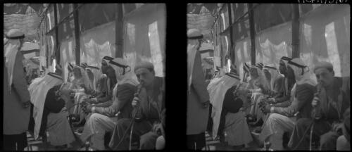 Sundry stereos, Jerusalem [informal gathering of men on street bench] [picture] / [Frank Hurley]