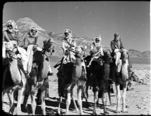 Camel detachment [five soldiers in Arab dress on camels from the front] [picture] : [Jordan] / [Frank Hurley]