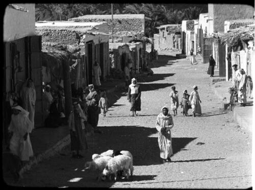 Kerak [street scene with children, sheep and adults] [picture] : [Jordan] / [Frank Hurley]