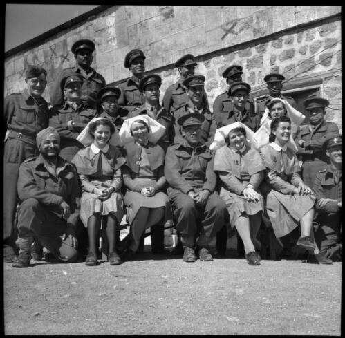 [Various female and male personnel arranged in a tiered pose, World War II, 1] [picture] : [Iran] / [Frank Hurley]