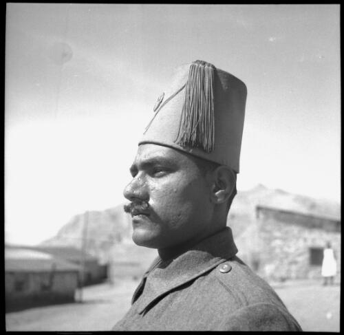 [Close up portrait of male with distinctive uniform and headdress, World War II] [picture] : [Iran] / [Frank Hurley]