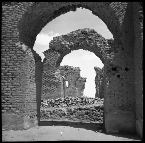 [Looking through consecutive arches of stone ruins, World War II] [picture] : [Iran] / [Frank Hurley]