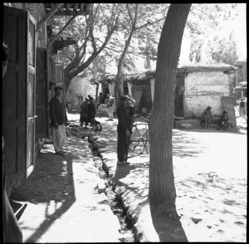 [Stable-style workshops, dirt roads, trees and people, World War II] [picture] : [Iran] / [Frank Hurley]