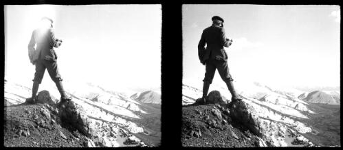 Scenes along the road from Taheran [Tahran] that leads to Mt. Damavend [Damavand] [male figure in uniform, holding a camera, overlooking from a great height, a panorama of mountains and valleys, World War II] [picture] : [Iran] / [Frank Hurley]