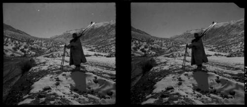 Rd to Russia, scenes around the Paitak Shah Passes [male figure clothed in a long fur jacket, holding a pair of skis, World War II] [picture] : [Iran] / [Frank Hurley]