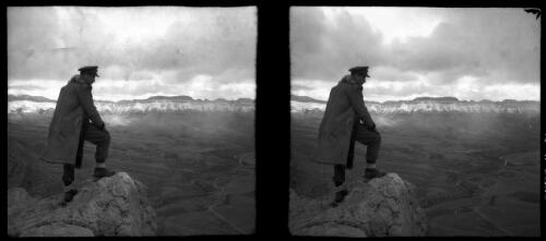 Rd to Russia, scenes around the Paitak Shah Passes [uniformed male figure overlooking the panorama of a valley and surrounding mountains, the road traverses the valley floor beside a ravine, World War II] [picture] : [Iran] / [Frank Hurley]