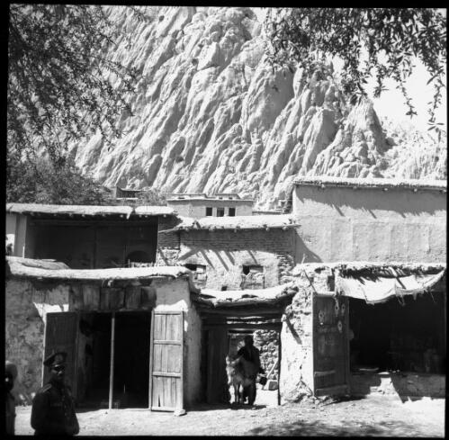 [Dwellings backdropped by a steep rocky incline, World War II] [picture] : [Iran] / [Frank Hurley]