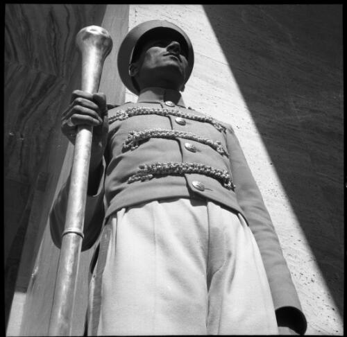 Sunday shots, Iran [guard or doorman holding a staff, World War II] [picture] : [Iran] / [Frank Hurley]