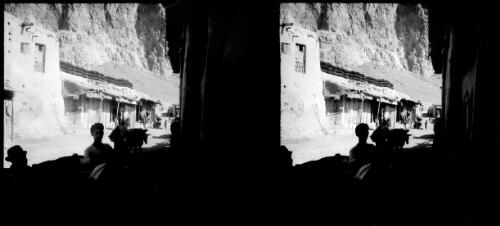 Village of Beisitun Persia, row of shops in the shade of Beisitun mountain [picture] : [Iran] / [Frank Hurley]