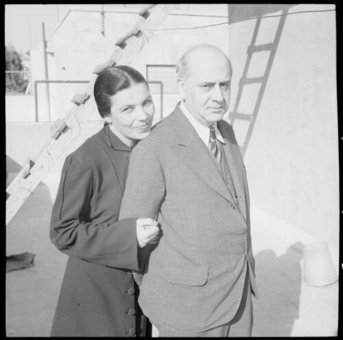 [Portrait of a man and a woman, standing in front of a ladder] [picture] : [Iran, World War II] / [Frank Hurley]