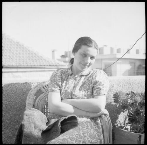 [Portrait of a woman seated in a wicker chair on a balcony] [picture] : [Iran, World War II] / [Frank Hurley]