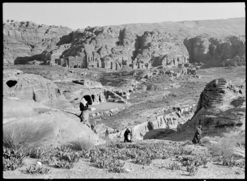 Petra valley [figures and cactuses in the foreground] [picture] : [Petra Valley, Jordan] / [Frank Hurley]