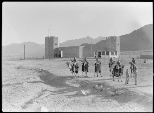[Stone fort with Arab Legionnaires and camels in front, ca. 1940-1946, 1] [picture] : [Petra Valley, Jordan] / [Frank Hurley]