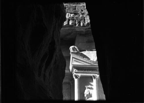 Petra [glimpse through a rocky passageway to part of the Khazna tomb ca. 1940-1946] [picture] : [Petra Valley, Jordan] / [Frank Hurley]