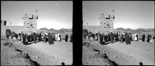 At the police post ready to set out for Petra valley [figures foreground including a truck and horse ca. 1940-1946] [picture] : [Petra Valley, Jordan] / [Frank Hurley]