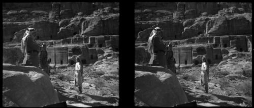 [Two Arab legionnaires and child with monuments behind, ca. 1940-1946] [picture] : [Petra Valley, Jordan] / [Frank Hurley]
