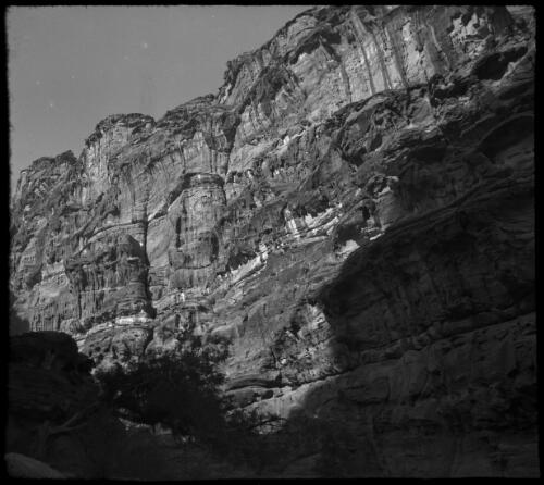 Glimpse in the valley of Petra, lying between the Dead Sea & the Gulf of Aquaba, stereo [rock face ca. 1940-1946] [picture] : [Petra Valley, Jordan] / [Frank Hurley]
