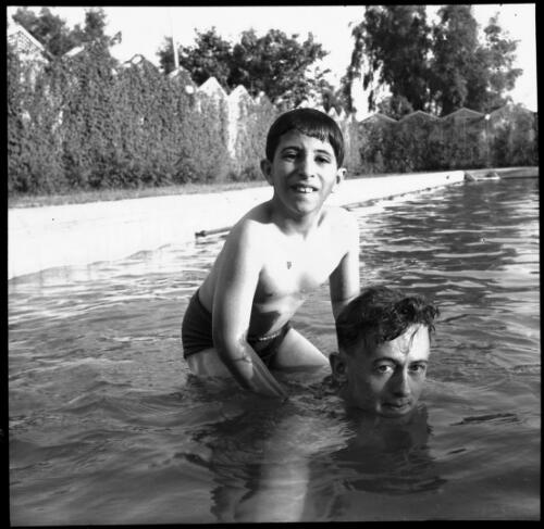 Feisal with his swimming master in the Palace Pool [picture] : [Iraq, World War II] / [Frank Hurley]