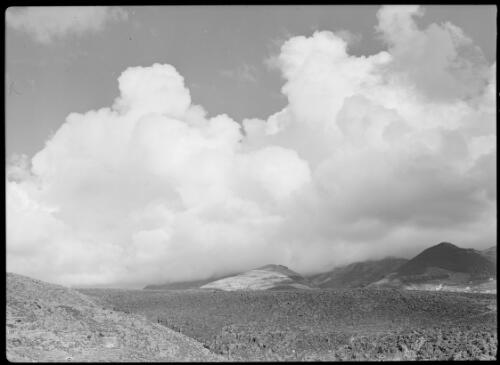 [Cloud formation over a mountainous landscape] [picture] / [Frank Hurley]