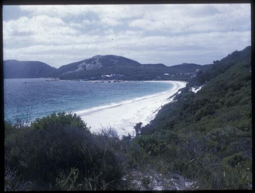 [View of shoreline wiht white sand and mountain in the background] [transparency] / [Frank Hurley]