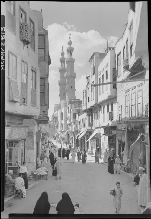 The twin minarets of Mosque El Mu'ayyad above the old Cairo gate, Bab El Mitwelly [El-Mu'ayyad Mosque or Red Mosque] [picture] : [Cairo, Egypt, World War II] / [Frank Hurley]