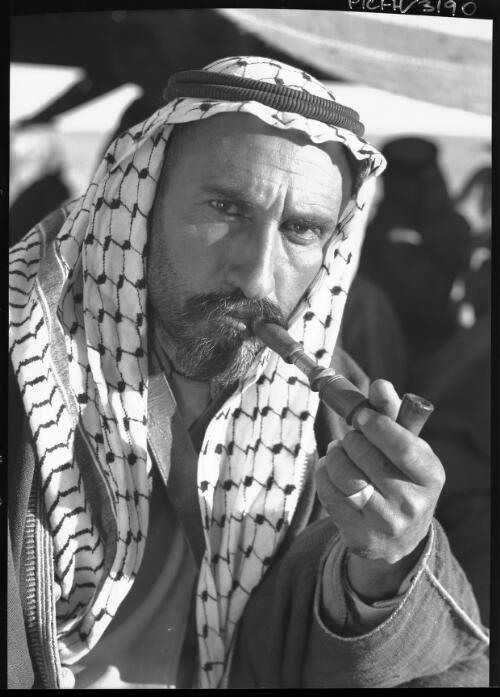 Sheikh Jirwan Mijali smoking Ghalyoun (Bedouin pipe) [picture] : [Portrait Studies, Libya, World War II] / [Frank Hurley]