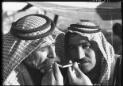 2 Bedouins lighting cigarettes [picture] : [Portrait Studies, Libya, World War II] / [Frank Hurley]