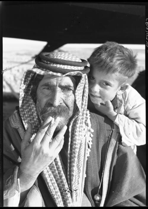 [Arab man with a cigarette and a boy] [picture] : [Portrait Studies, Libya, World War II] / [Frank Hurley]
