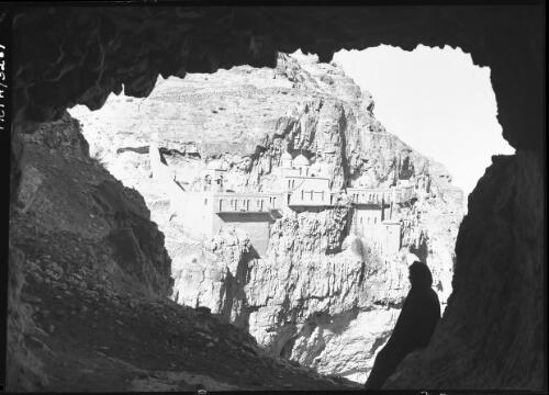 [The Greek monastery Quruntul on the Mount of Temptation seen from the mouth of a hermit's cave] [picture] / [Frank Hurley]