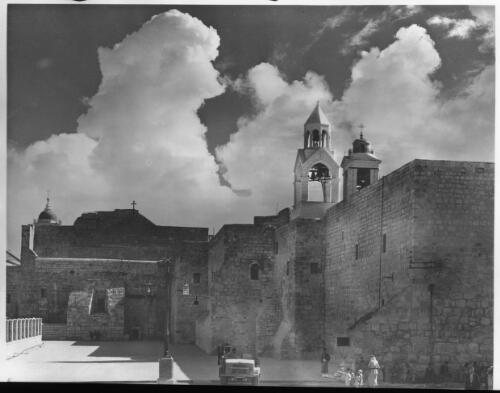 Church of Nativity Bethlehem [with figures and a Land Rover or Jeep motor vehicle, ca. 1942] [picture] / [Frank Hurley]