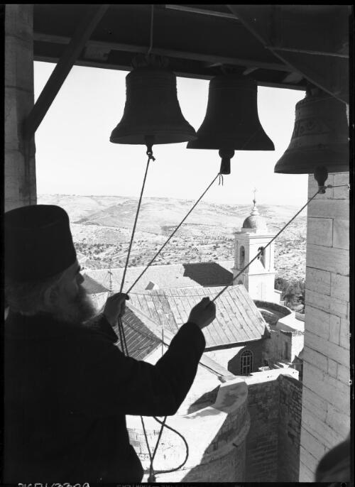 Belfrey of the Greek Basilica Bethlehem [with a figure ringing the bells, ca. 1942] [picture] / [Frank Hurley]