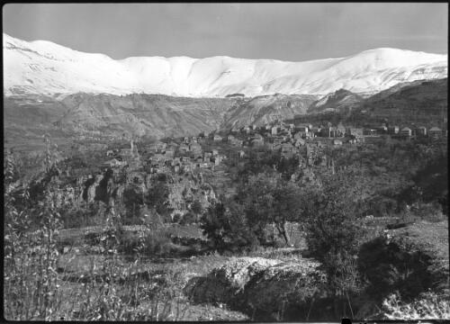 Typical scene in Lebanons on way to the Cedars [distant village surrounded by mountains] [picture] : [Lebanon, World War II] / [Frank Hurley]