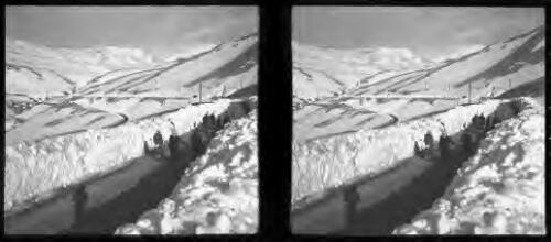 Winter scenes at Ainsofar [figures on road, some carrying shovels] [picture] : [Syria, World War II] / [Frank Hurley]