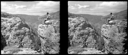 In the Lebanons, the Great Gorge of the Quadisha below Becharre [Bcharre, Allied officer sitting on the edge of a gorge] [picture] : [Lebanon, World War II] / [Frank Hurley]