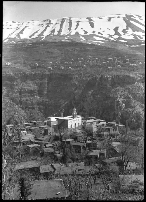Hajit is perched on the brink of the deep canyon of the Quadisha in the background to over the summits of the Lebanons (Hajjit is on the way to the Cedars) [picture] : [Lebanon, World War II] / [Frank Hurley]