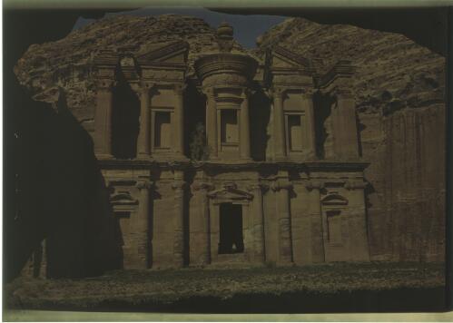 [Monastery (Al-Deir), Petra, with standing figure at entrance] [picture] : [Jordan, World War II] / [Frank Hurley]