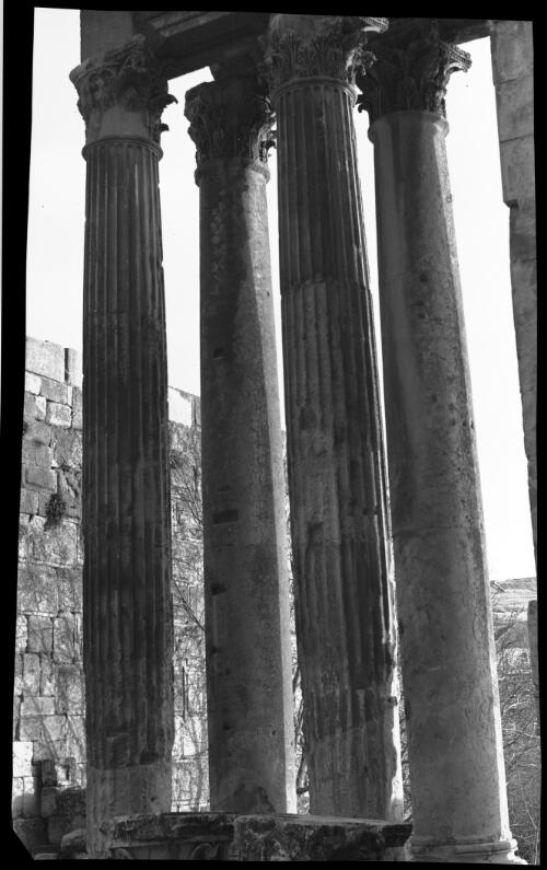 Details of adornment Baalbek, Syria [four columns with Corinthian-style capitals, two fluted] [picture] : [Lebanon, World War II] / [Frank Hurley]