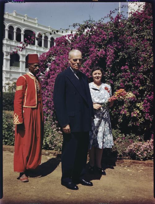 The Governor General & Lady Huddleston accompanied by a footman take an afternoon stroll in the lovely palace garden at Khartoum [picture] : [Sudan, 1940's] / [Frank Hurley]