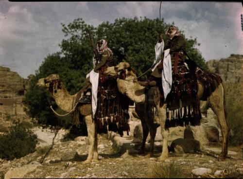 [Two Allied soldiers on camels in profile, Arab military dress] [picture] : [Sudan, 1940's] / [Frank Hurley]