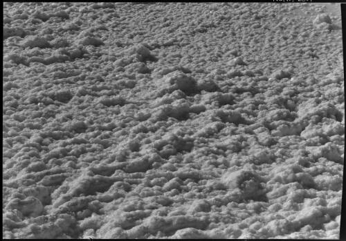 Southern end of Dead Sea showing salts crystallizing in the vast shallow evaporation pools of Palestine Potash Company [close-up view of salt formations] [picture] / [Frank Hurley]