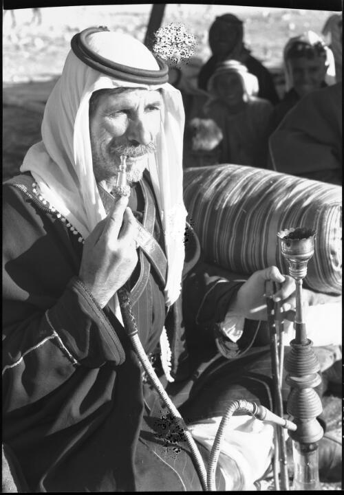 [Bedouin smoking a pipe] [picture] : [Jordan] / [Frank Hurley]