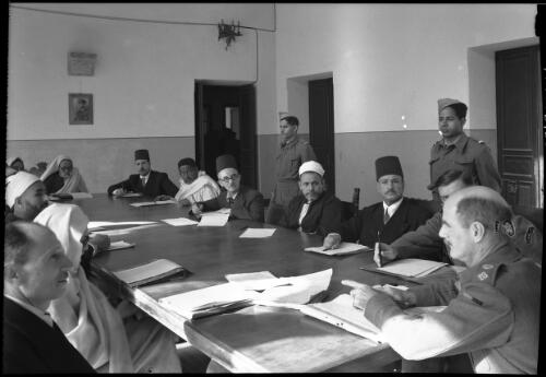 Here the municipal council of Benghazi, composed of prominent Senussi personnel, is attending to municipal affairs under the chairman of a Civil affairs officer (British) [ca. 1940-1946] [picture] : [Barqah, Libya] / [Frank Hurley]