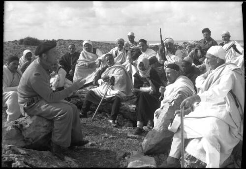 A British Civil Affairs officer (Major Sholto-Douglas) has a pow-wow with the Shiekhs of Ptolemetta [Tolmeta, ca. 1940-1946] [picture] : [Barqah, Libya] / [Frank Hurley]