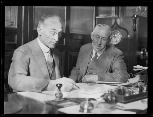 Mr A. McTavish, Manager of the Government Savings Bank with another man at his desk, New South Wales, 1931 [picture]