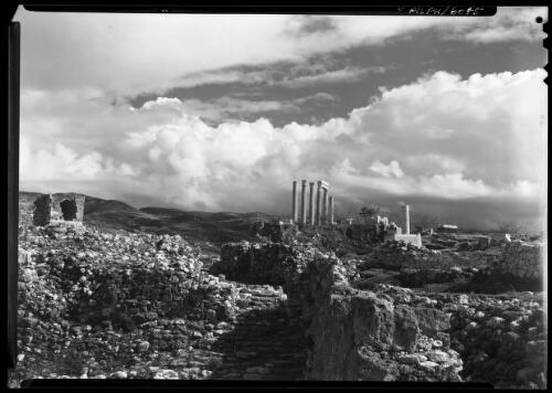 [Ancient ruin showing a group of corinthian columns in the middleground, two joined with a lintel, ca. 1940-1946] [picture] : [Barqah, Libya] / [Frank Hurley]