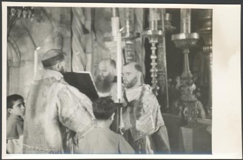 [Priests at altar during a service, Church of the Holy Sepulchre, Jerusalem] [picture] / [Frank Hurley]