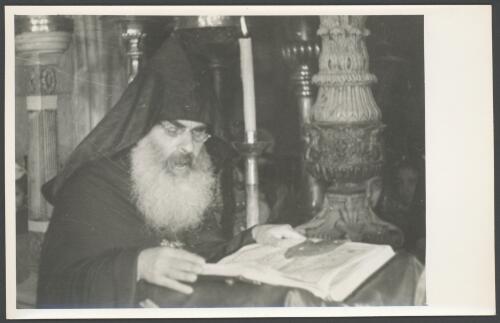 [Armenian priest reading from Bible, Church of the Holy Sepulchre, Jerusalem] [picture] / [Frank Hurley]
